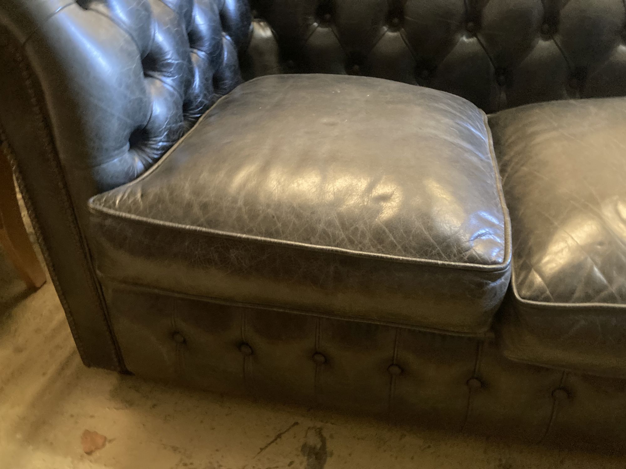 A Fleming & Howland, Chesterfields buttoned black leather three seater Chesterfield settee, length 200cm, depth 86cm, height 74cm